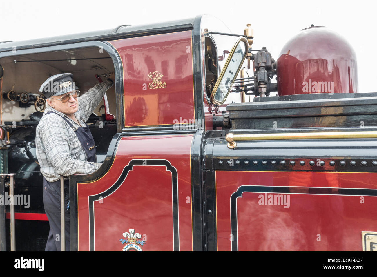 Engine driver in steam locomotive cab, Ffestiniog and Welsh railway, Porthmadog, Wales, UK Stock Photo