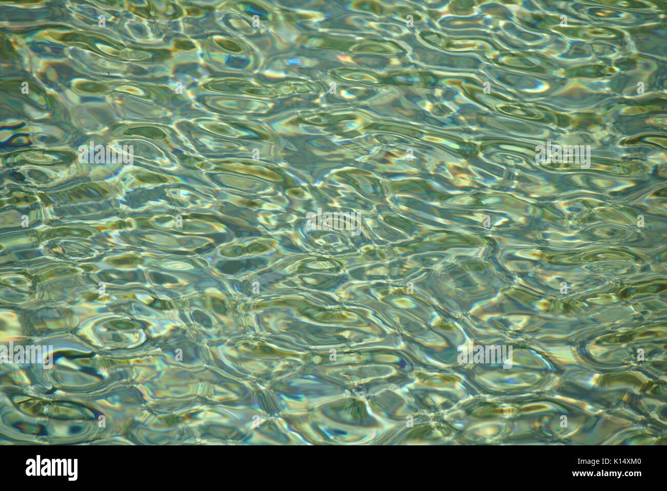 Rippling water surface with bright reflections of sunlight Stock Photo