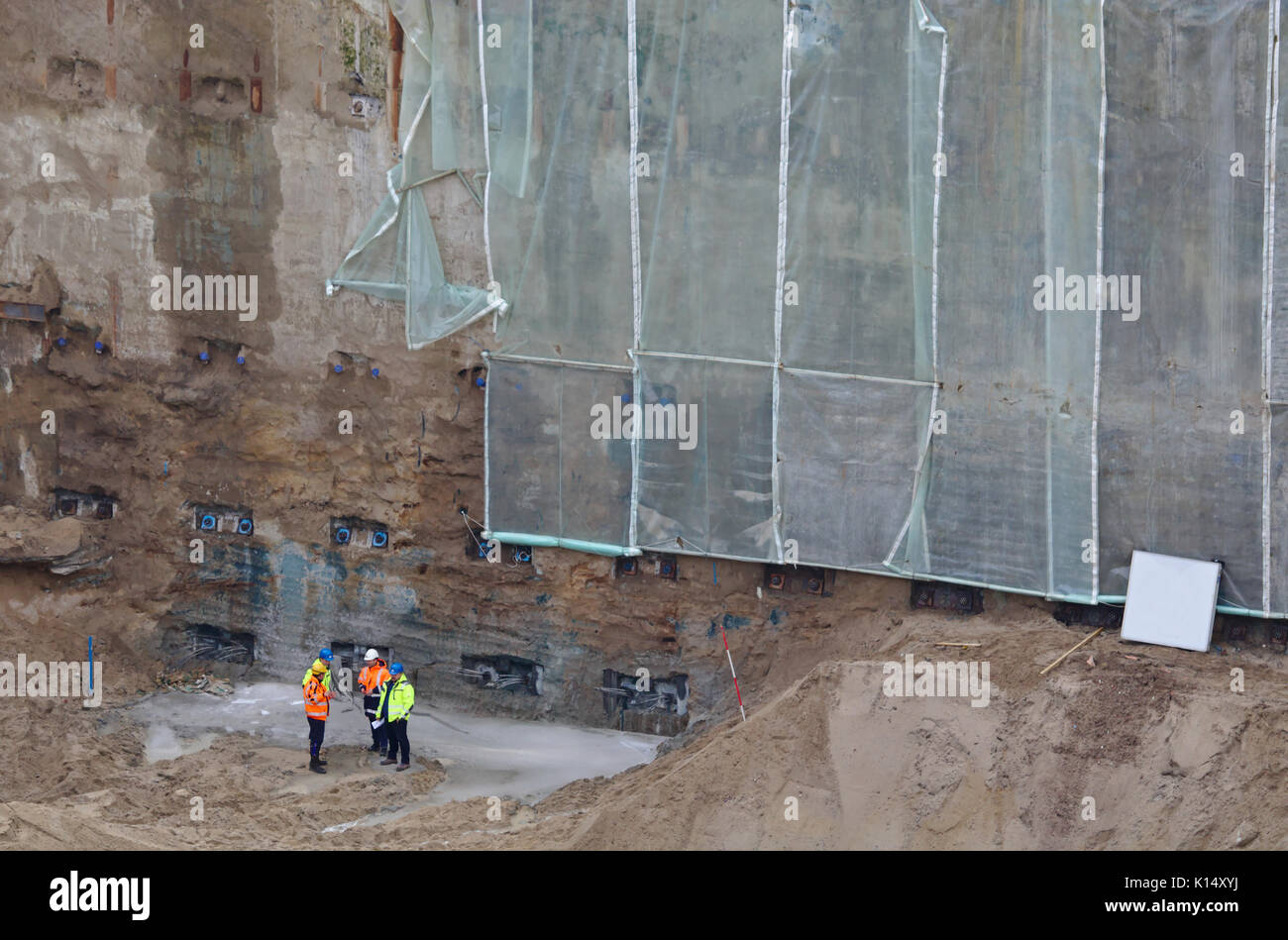 Civil engineers during a meeting with their supervisor in a huge excavation Stock Photo