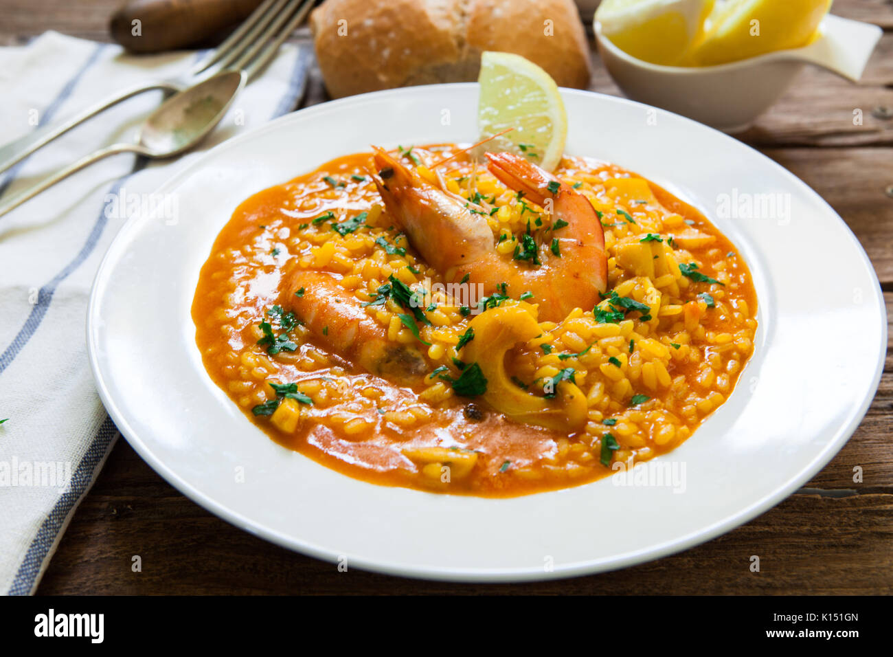 spanish seafood rice with squid and prawns Stock Photo