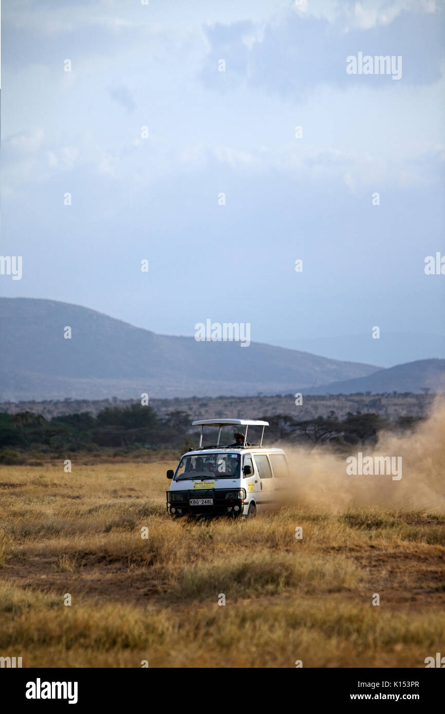 Safari rig filled with tourists driving fast in search of game in the Samburu National Reserve, Kenya, Africa. Stock Photo
