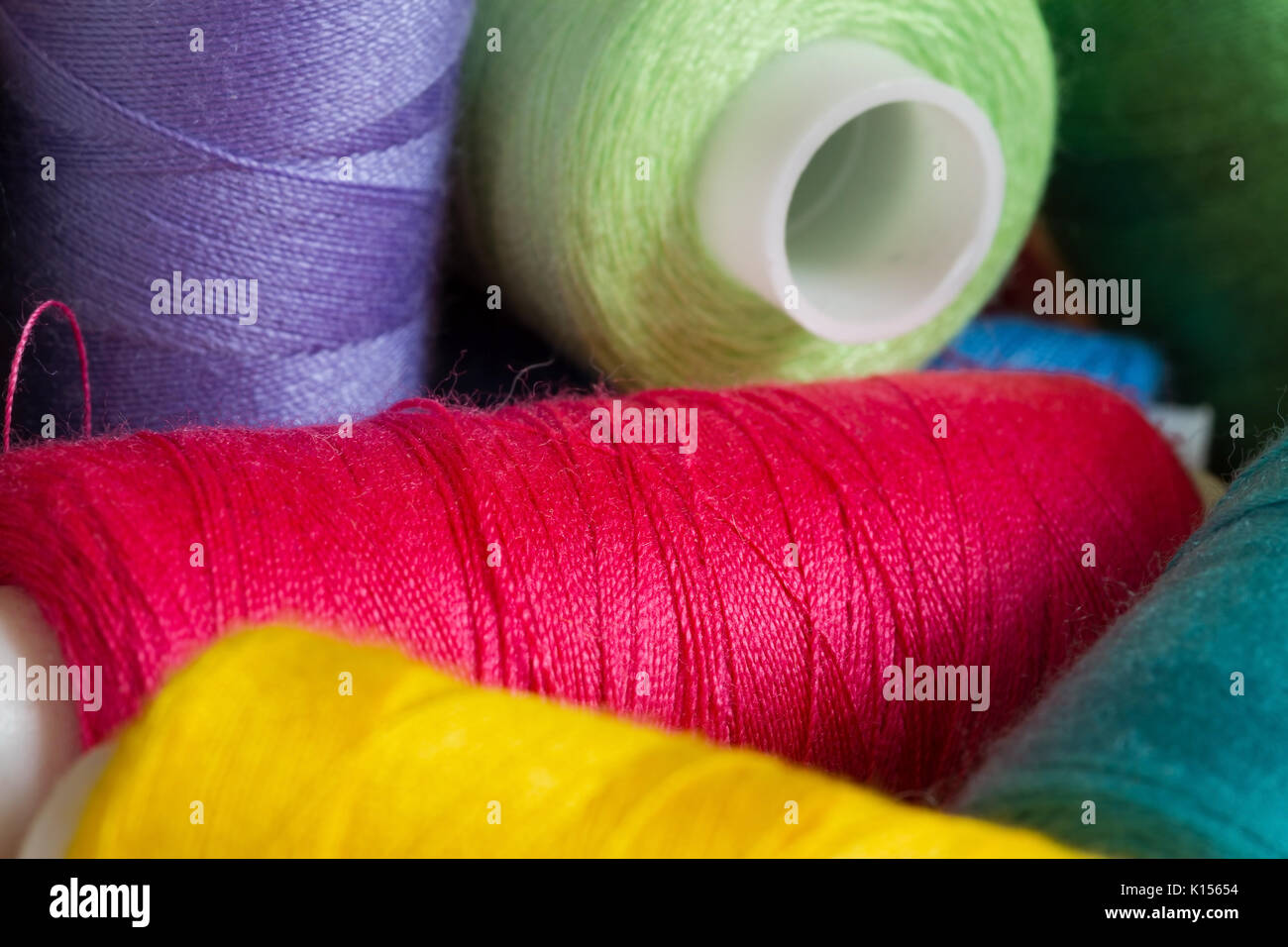 Pile of coloured bobbins of thread Stock Photo