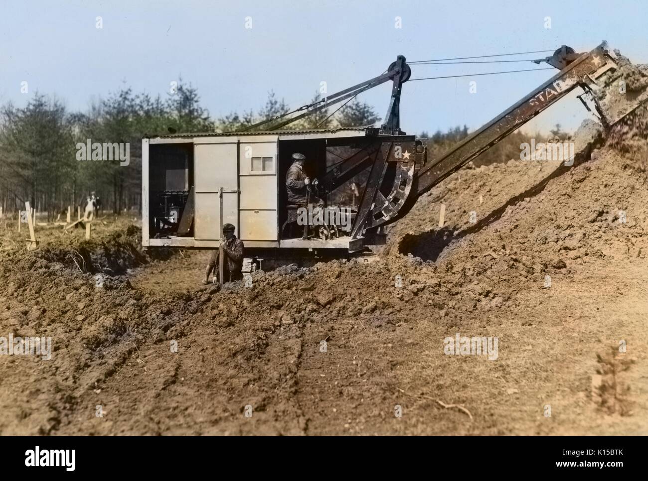 Mechanical digger working on cellar foundation at a Farm Security Administration housing unit at the Berwyn project, Greenbelt, Maryland, 1936. From the New York Public Library. Note: Image has been digitally colorized using a modern process. Colors may not be period-accurate. Stock Photo
