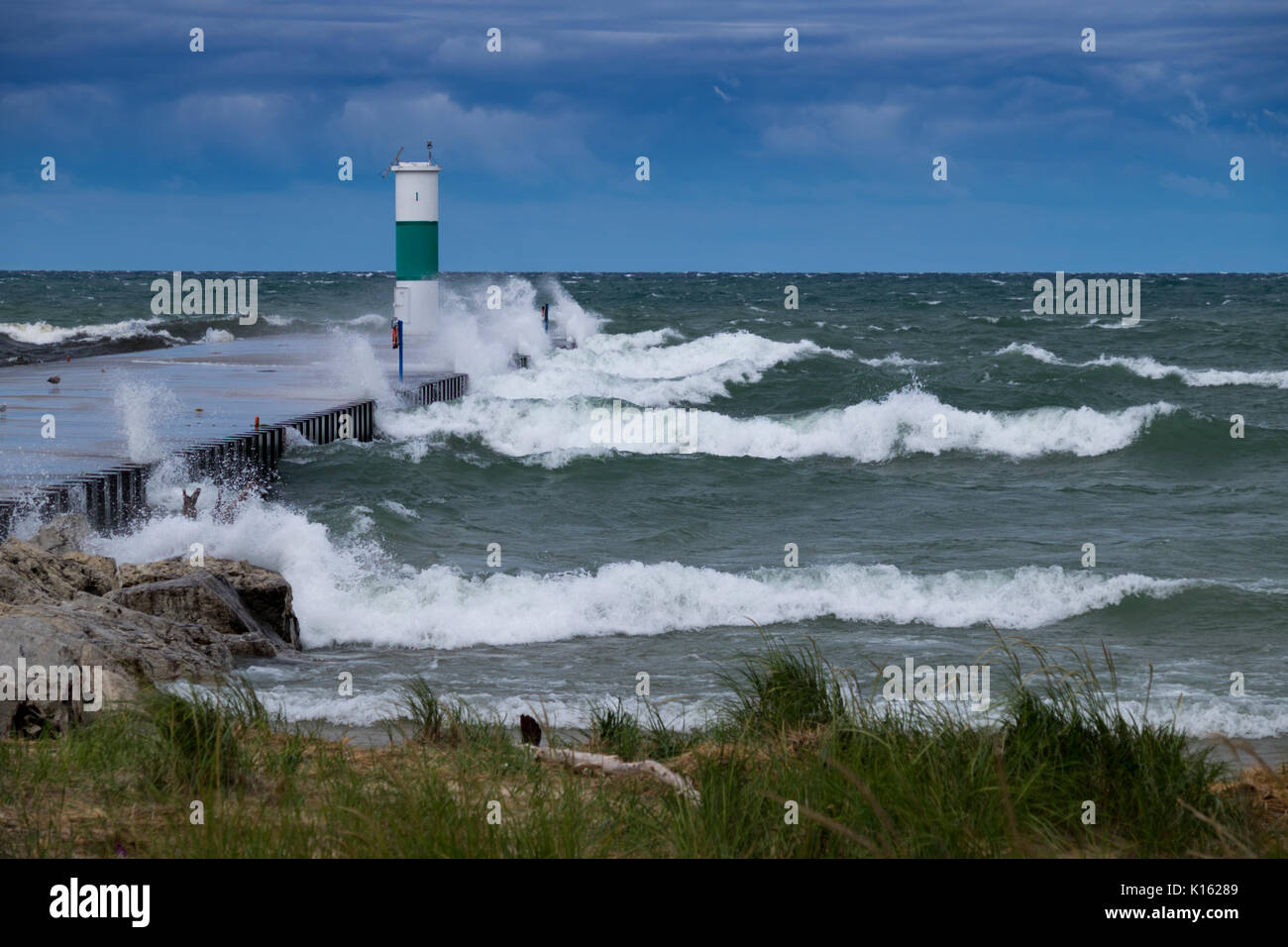 Lake Michigan waves crashing into the north pier of the White Lake Channel. Stock Photo
