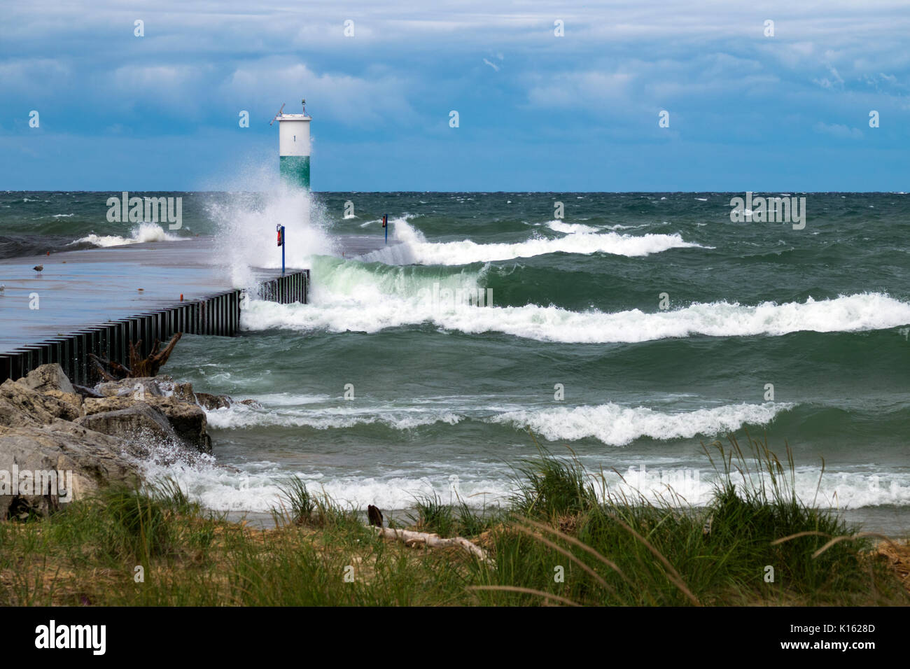 Lake Michigan waves crashing into the north pier of the White Lake Channel. Stock Photo