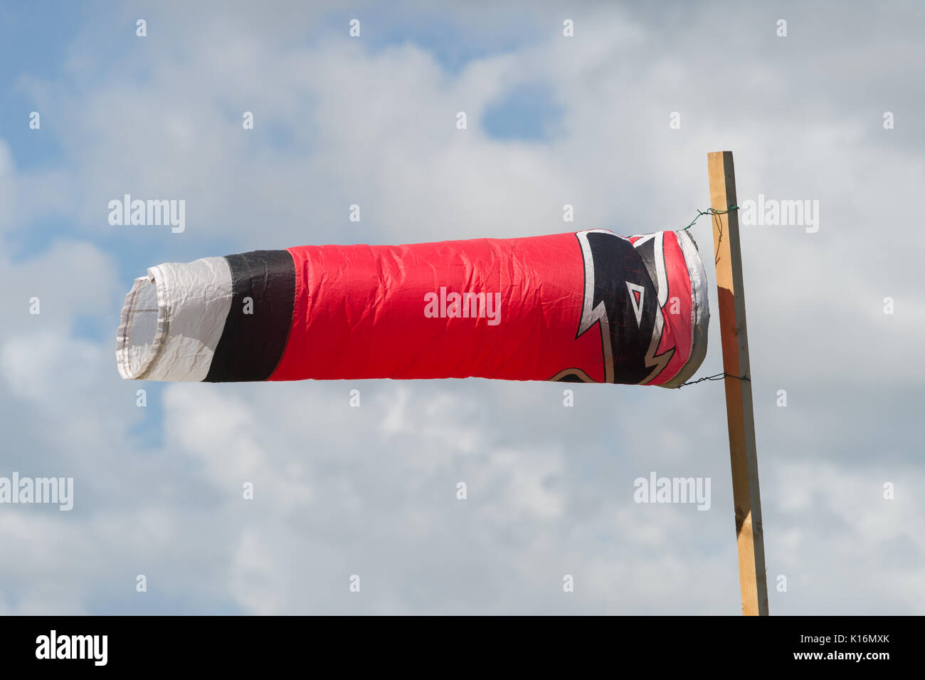 Windsock blowing in the wind in front of tropical landcape in Martinique, Caribbean Sea Stock Photo