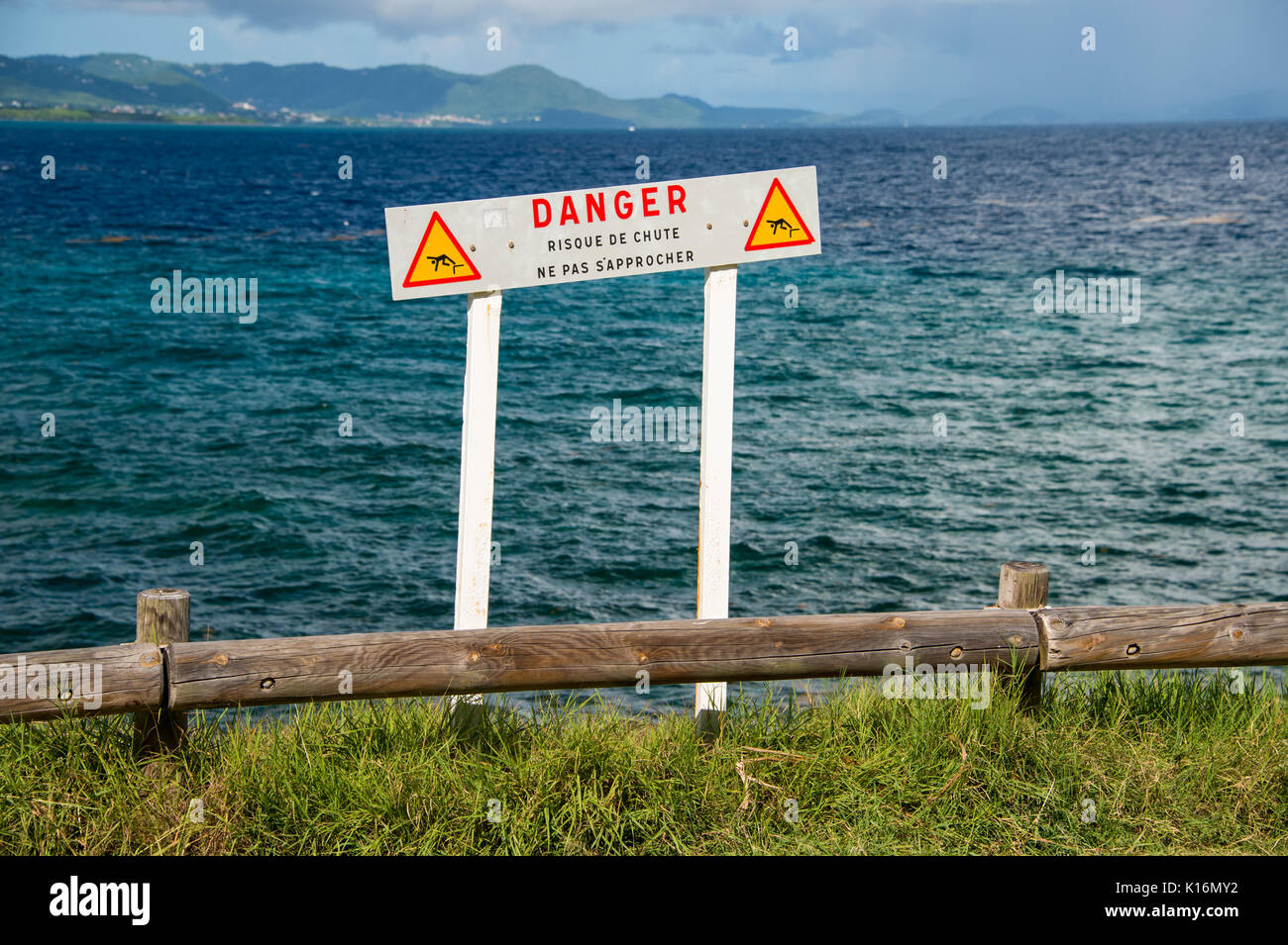 French sign warning people to keep away from a dangerous cliff edge in Martinique (Do not approach, risk of falling) Stock Photo