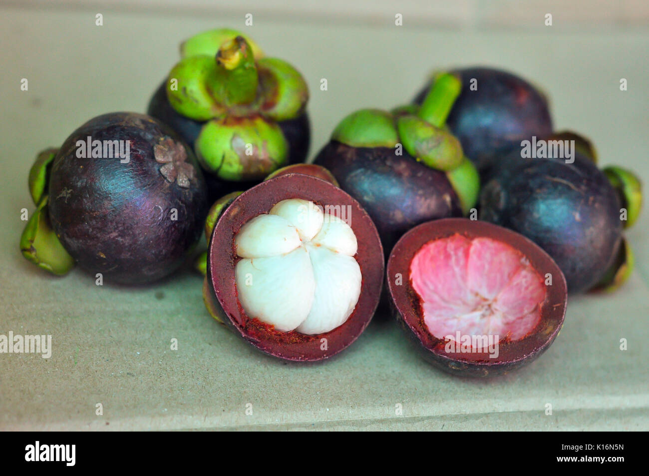 Purple mangosteen fruit exterior and in crosssection Stock Photo Alamy