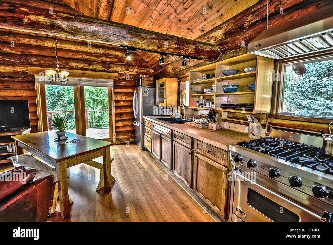 Kitchen of a log home in the mountains with stainless appliances and hardwood floors Stock Photo