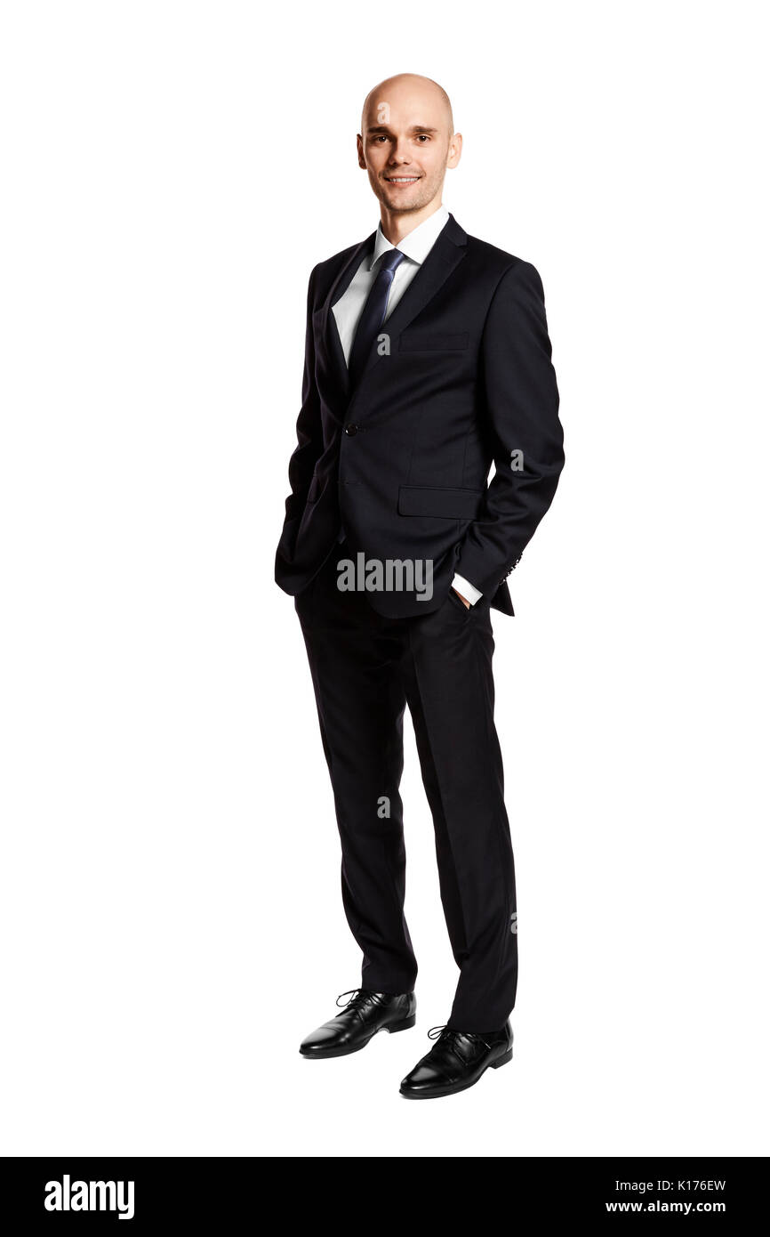 Full length portrait of young man i black suit. Hands in pockets. Isolated on white. Stock Photo