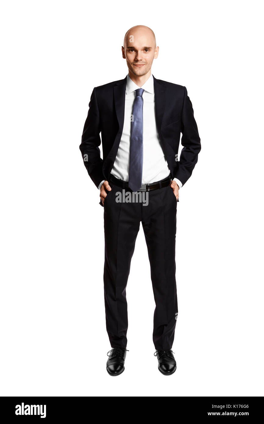 Full length portrait of young man i black suit. Hands in pockets. Isolated on white. Stock Photo