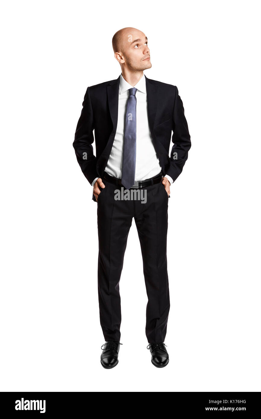 Full length portrait of young man looking left. Hands in pockets. Isolated on white. Stock Photo