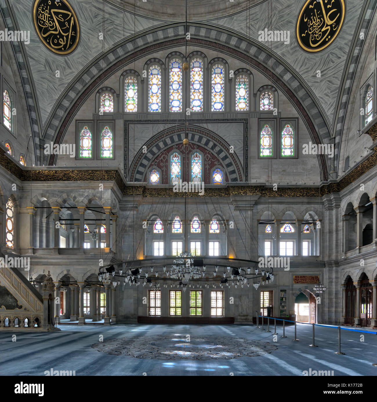Interior facade of Nuruosmaniye Mosque, an Ottoman Baroque style mosque completed in 1755, with a huge arch & many colored stained glass windows locat Stock Photo