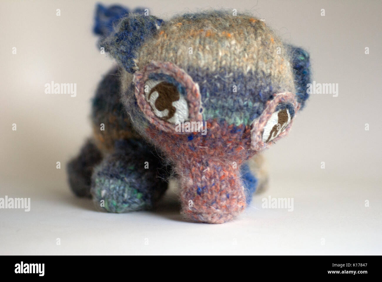 Pastel knitted elephant with embroidered eyes Stock Photo