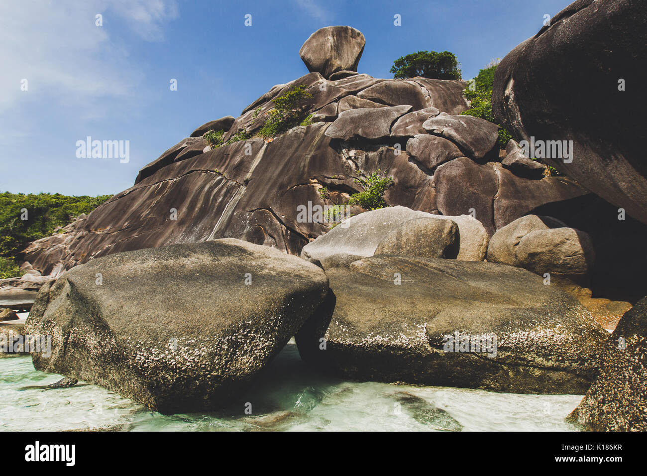 Rocky coast of paradise island with transparent crystal and clear water. Vacation in Similan Stock Photo