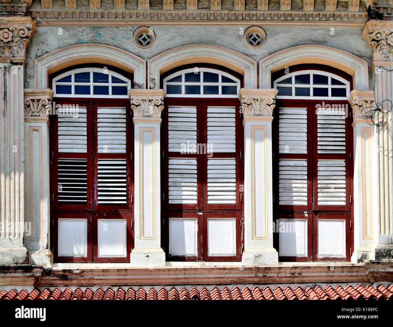 Traditional shop house exterior with white wooden louvered shutters