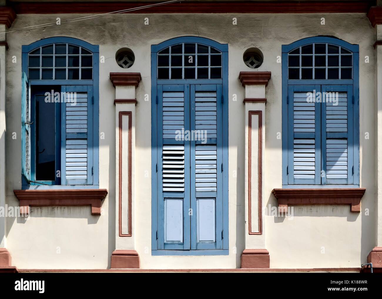 Traditional Shop House Exterior With Blue Wooden Louvered Shutters Arched Windows And Ornate Carvings In The Little India District Of Singapore Stock Photo Alamy