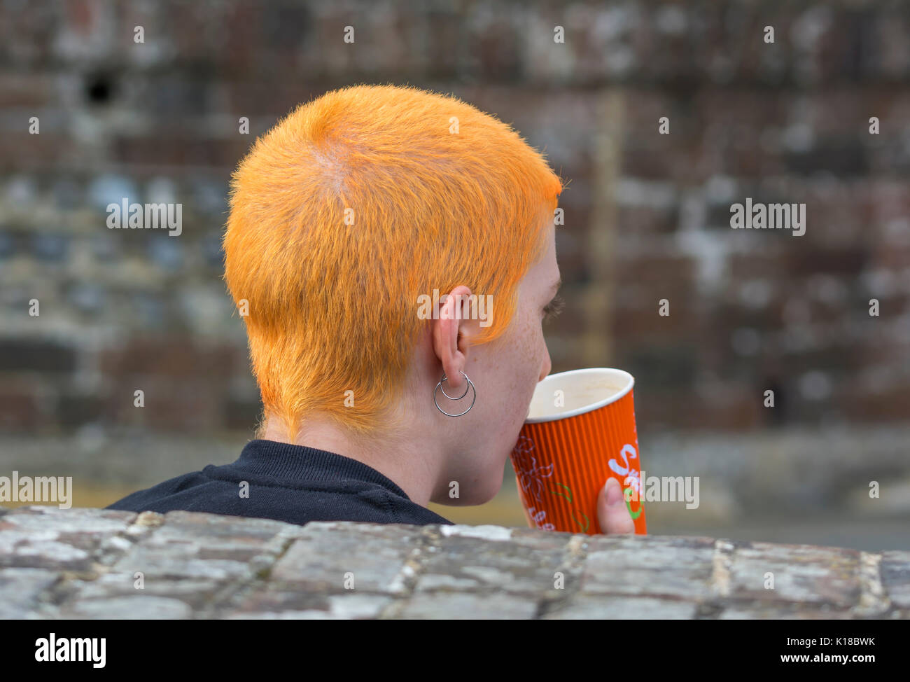 Young woman with very short orange hair. Woman with short hair. Stock Photo