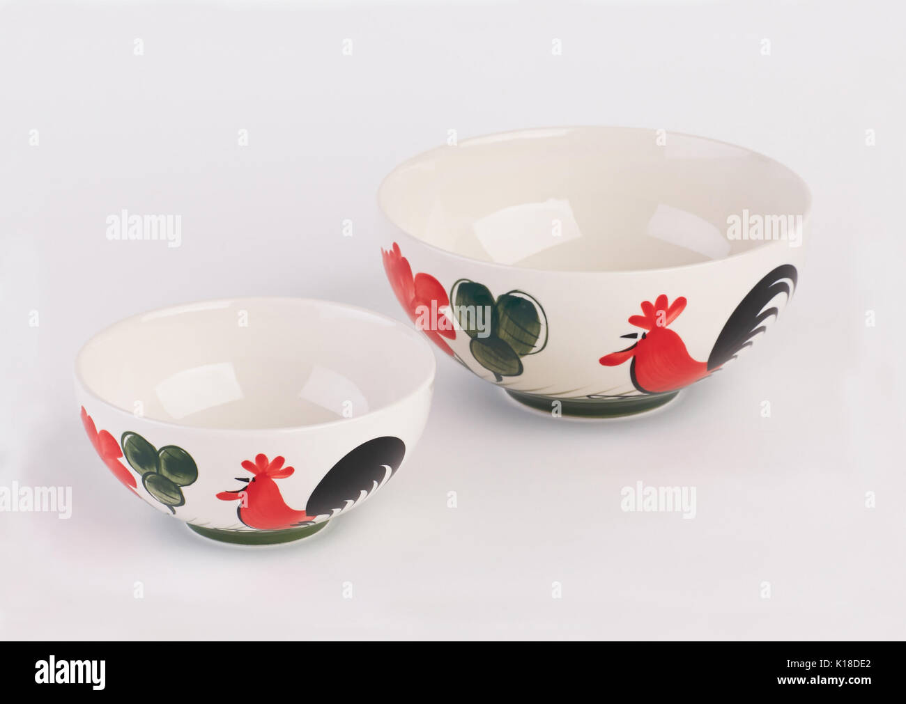 Big and small hand painted ceramic soup bowls isolated on white background Stock Photo