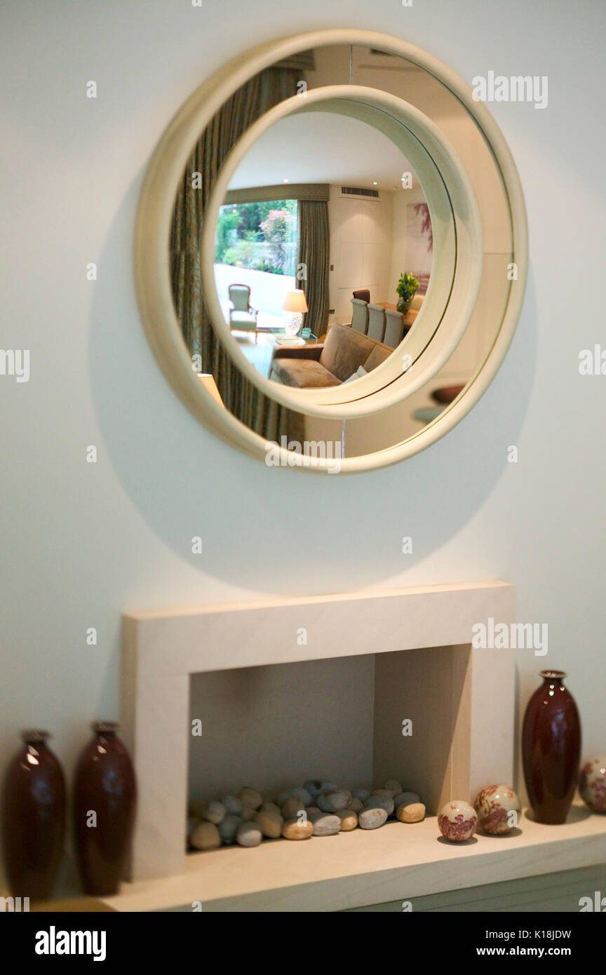 Round mirror and fireplace Stock Photo Alamy