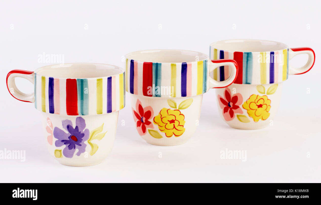 Lovely hand painted mugs isolated on white background Stock Photo