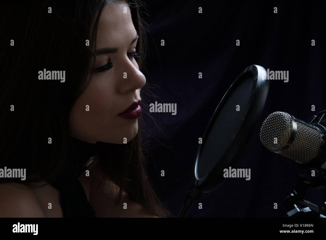 Beautiful girl In Recording Studio with microphone Stock Photo - Alamy