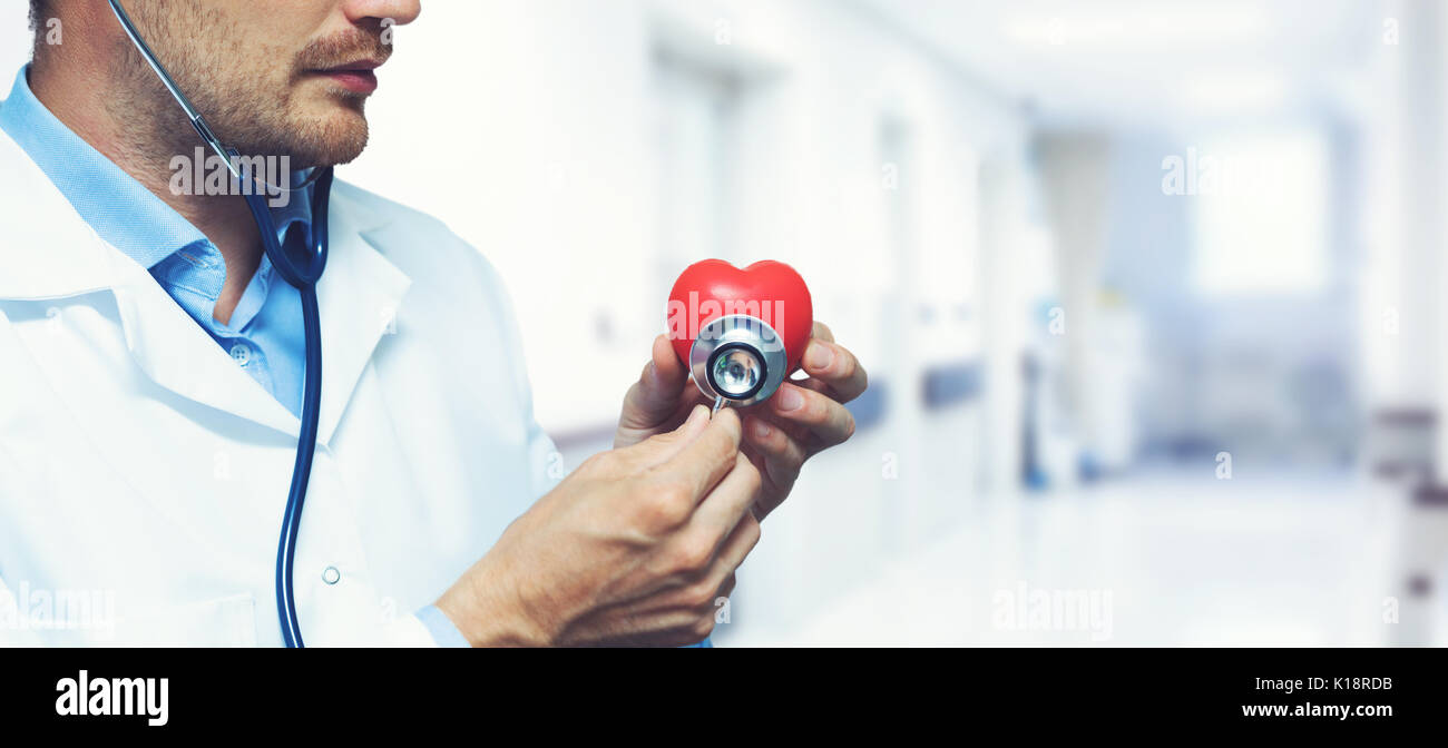 cardiology heart care concept - cardiologist with stethoscope in hospital hallway Stock Photo