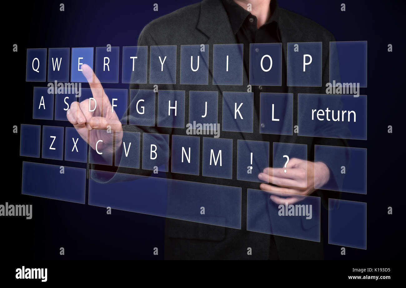 Man in black shirt and suit pointing his finger on virtual qwerty keyboard Stock Photo