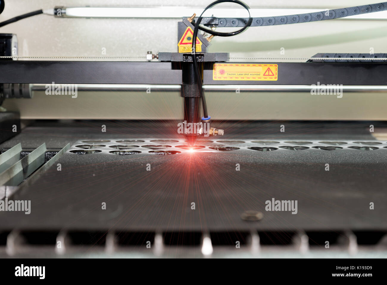 High precision CNC laser cutting metal sheet in factory. Stock Photo