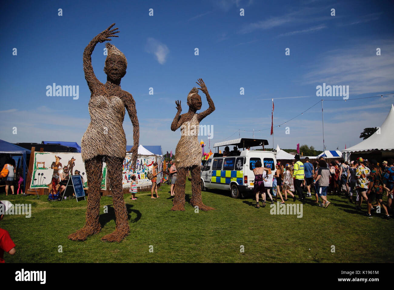 Northampton, UK. 25th August, 2017. A festival goer practices paddleboard yoga. The alternative festival famed for authentic music, crazy fancy dress and enthusiastic energy continues today under sunny skies on the Kelmarsh Estate. Credit: Wayne Farrell/Alamy Live News Stock Photo