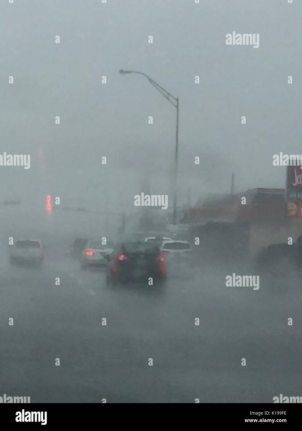 Galveston, Texas, USA. 25th Aug, 2017. Cars drive in heavy rain on Seawall Boulevard in