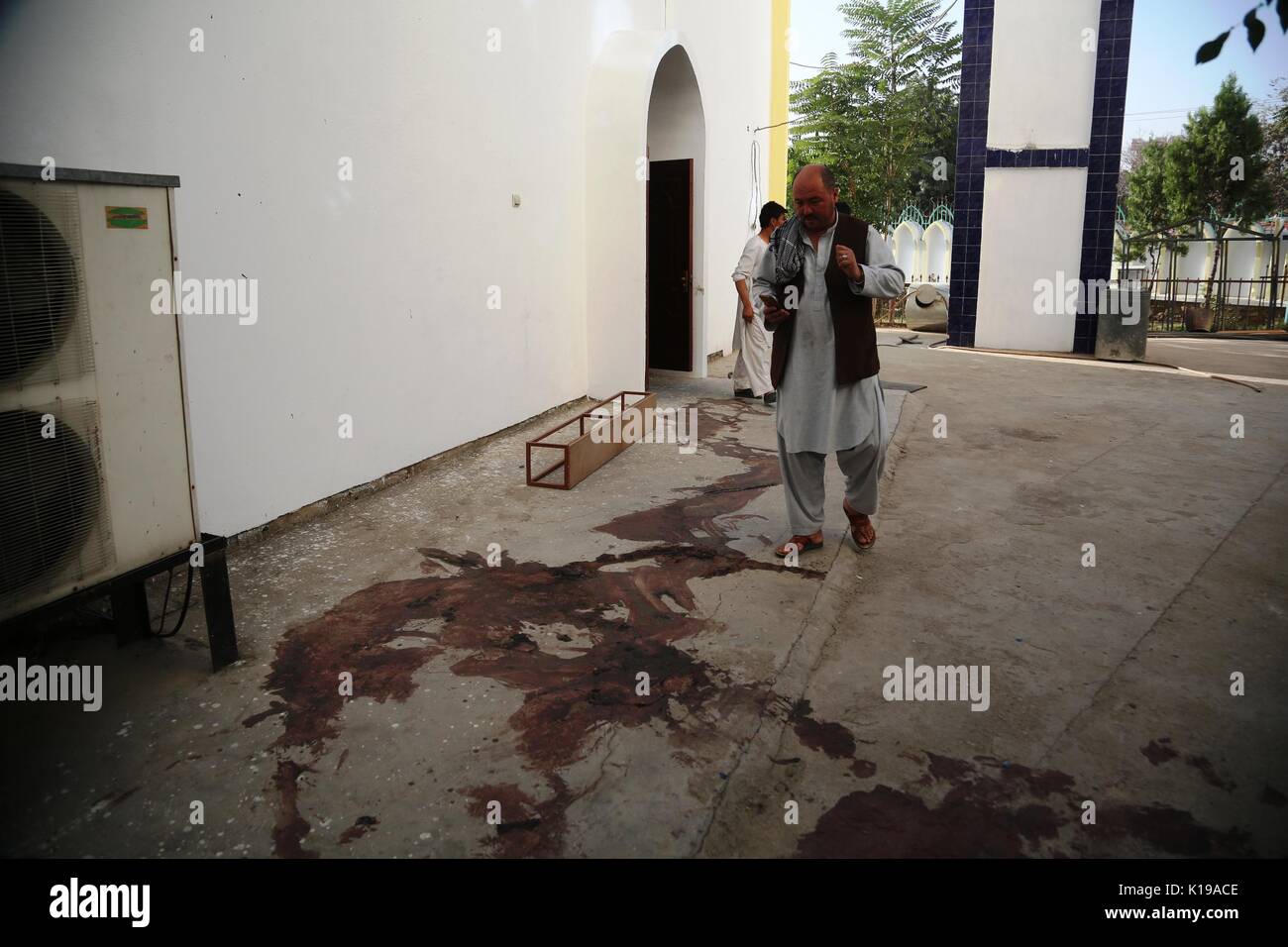 Kabul, Afghanistan. 26th Aug, 2017. A man walks at the site of attack in Kabul, capital of Afghanistan, Aug. 26, 2017. 2017. The death toll of the mosque attack on Friday has risen to 40 while 90 people were wounded, the Afghan Independent Human Rights Commission said on Saturday. Credit: Rahmat Alizadah/Xinhua/Alamy Live News Stock Photo