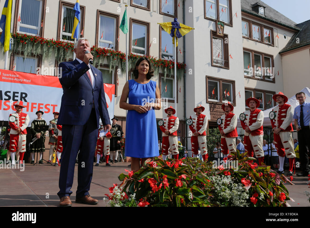 Worms, Germany. 26th August 2017. The Lord Mayor of Worms, Michael Kissel, addresses the audience. Daniela Schmitt stands next to him. The largest wine and funfair along the Rhine, the Backfischfest started in Worms with the traditional handing over of power from the Lord Mayor to the mayor of the fishermen’s lea. The ceremony was framed by dances and music. Secretary of state Daniela Schmitt from the Rhineland-Palatinate ministry for economy, transport, agriculture and viticulture attended the opening Credit: Michael Debets/Alamy Live News Stock Photo