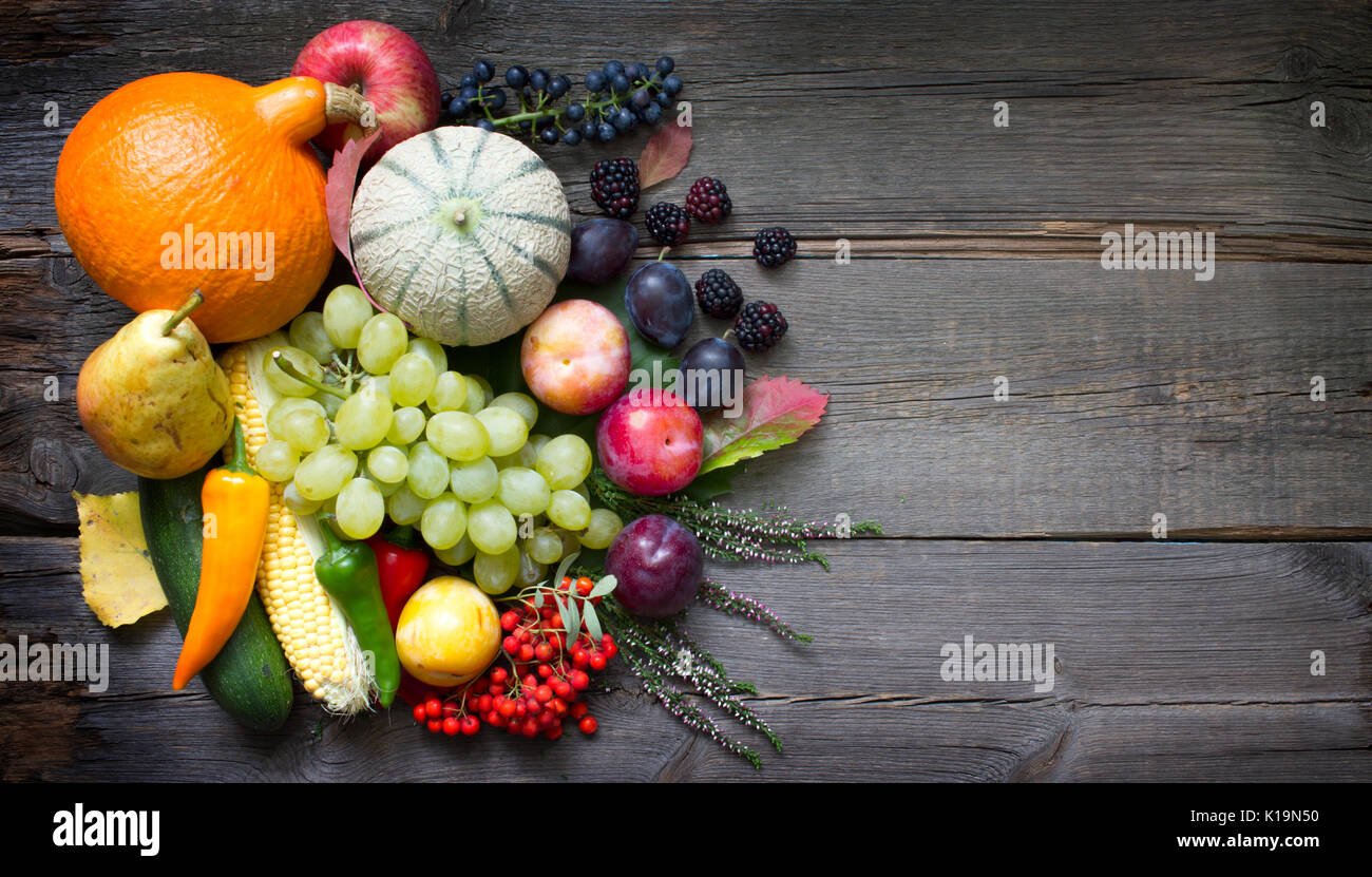 Autumn fruits and vegetables Still life on old wooden boards abstract ...