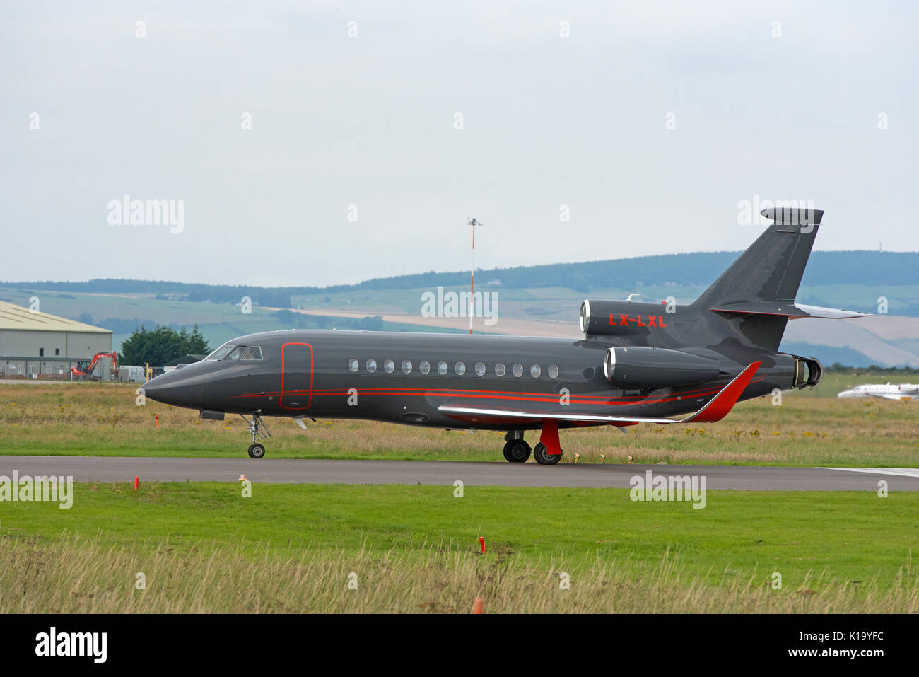 French Built Dassault 3 engined Business luxury jet aircraft at Invernees airport in the Scottish Highlands. Stock Photo