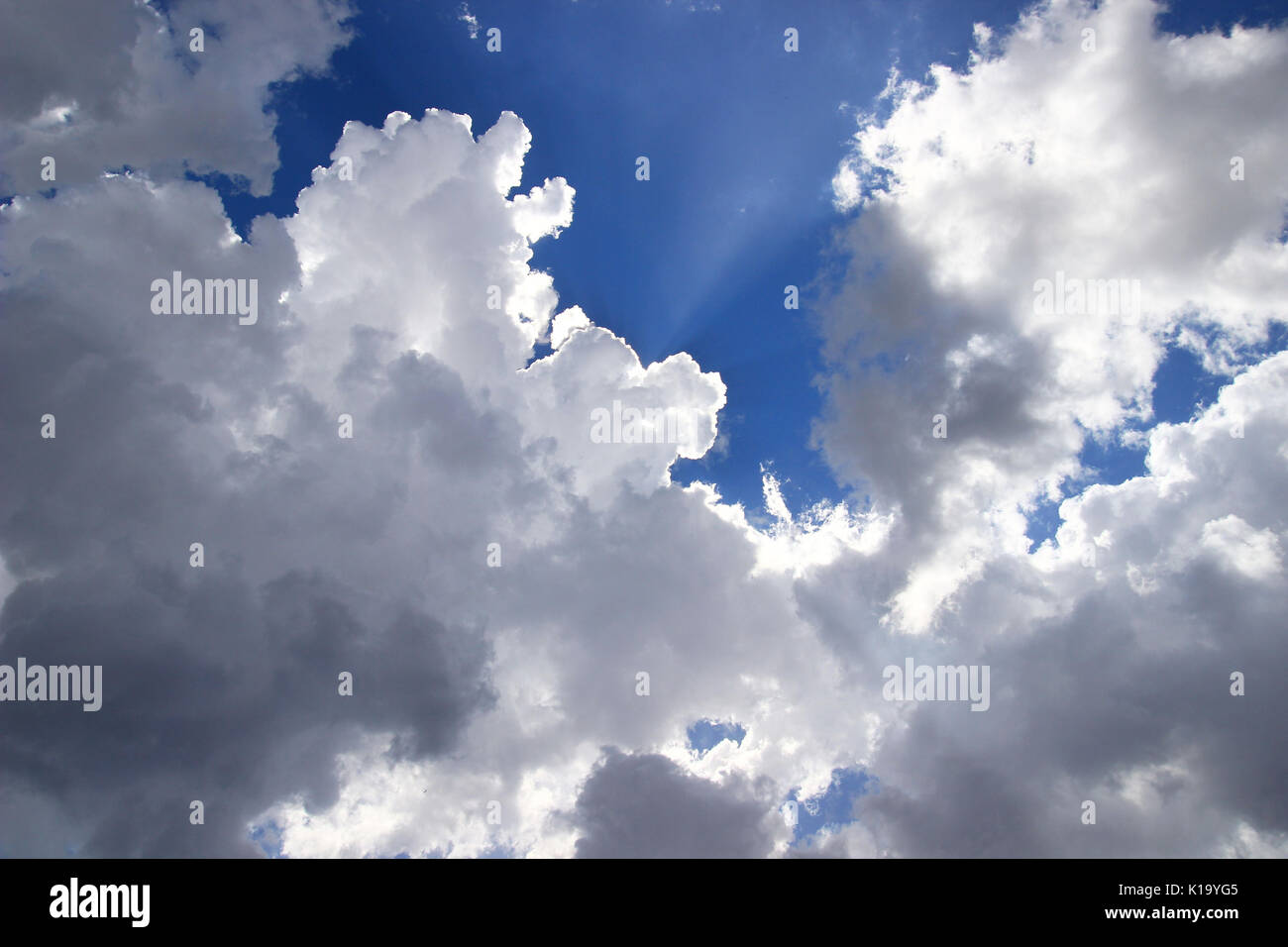 Clouds, sun rays and blue sky Stock Photo