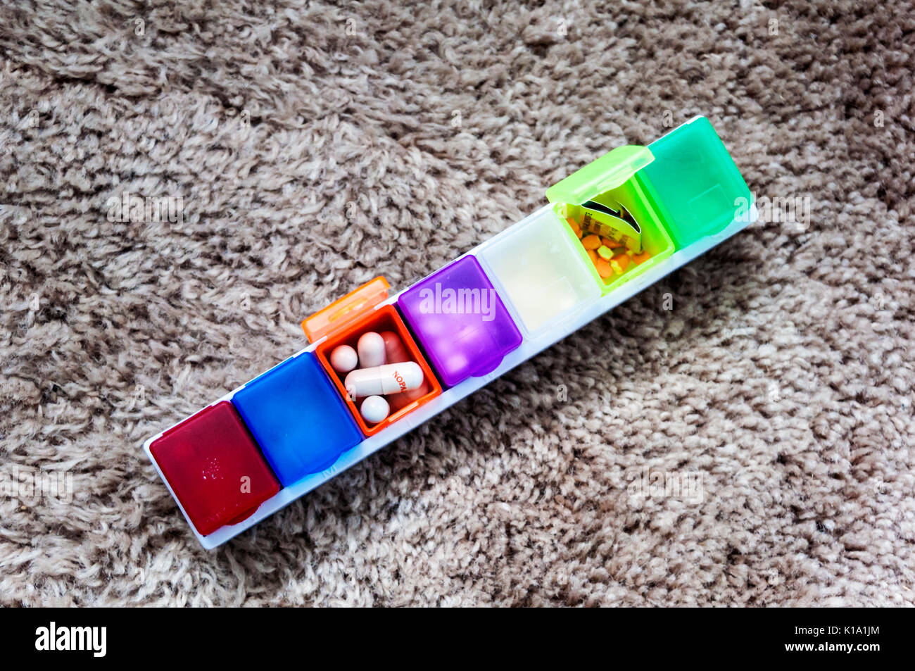 Pill box with compartments in many colours Stock Photo