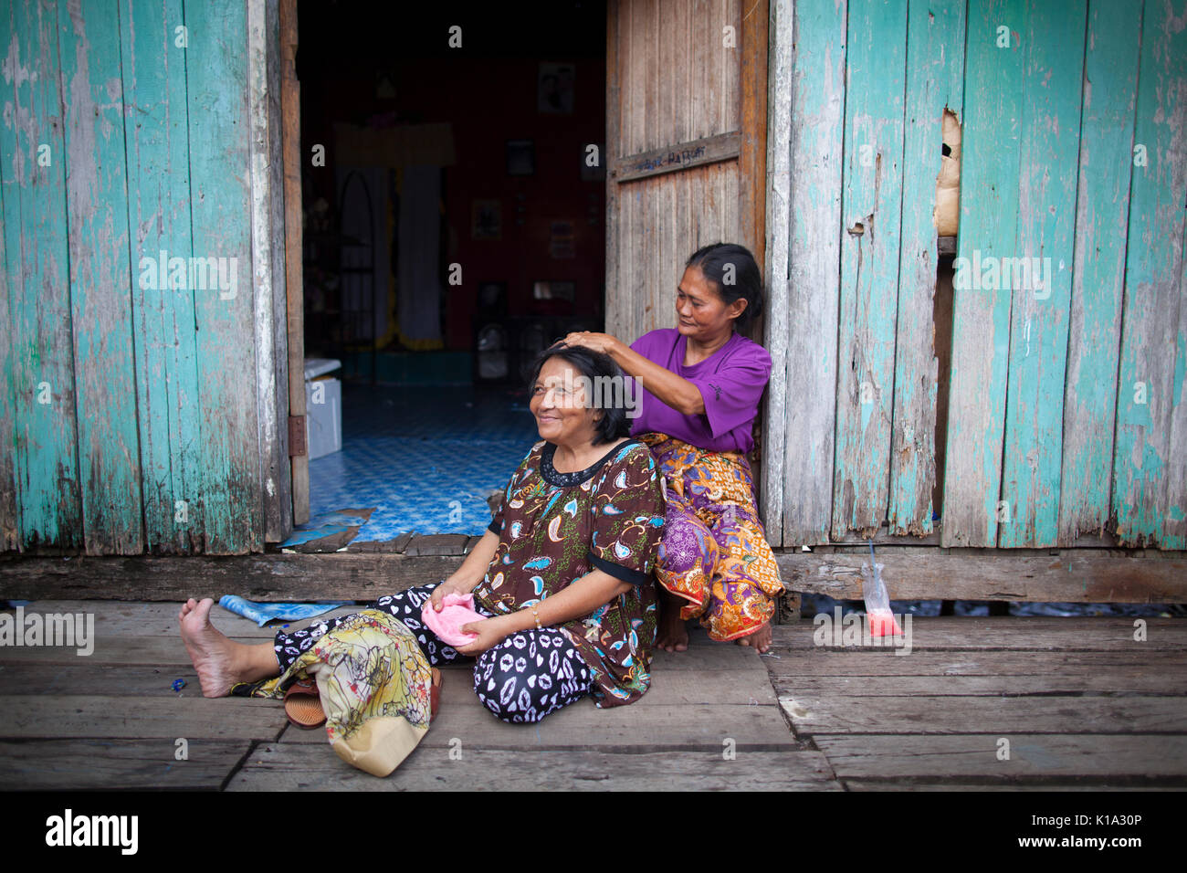 Bajau women spend time together in front of their house in Semporna town in Sabah. Malaysia. Stock Photo