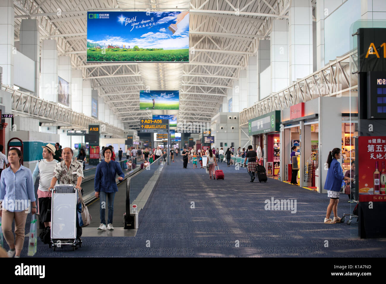 Passenger conveyor belt and shopping gallery in the boarding area at ...