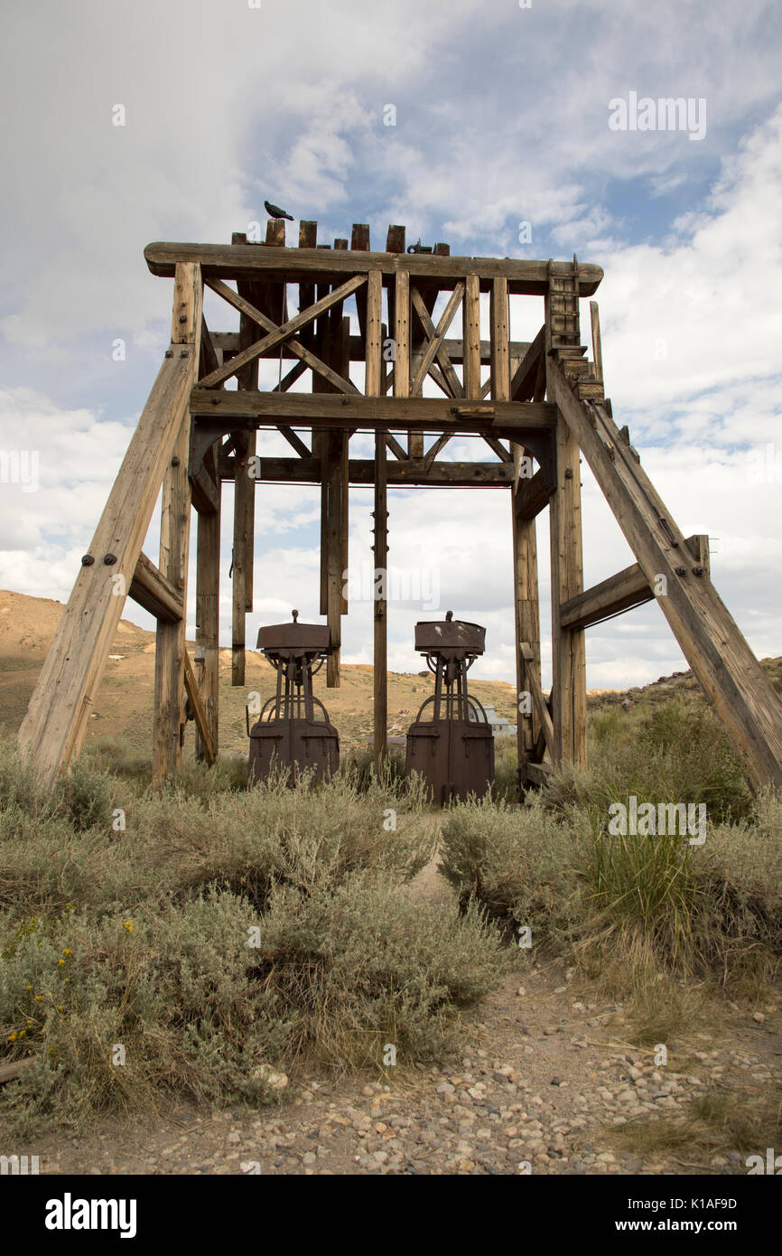 Mining cars under wooden A frame in Bodie State Historic Park, Stock Photo