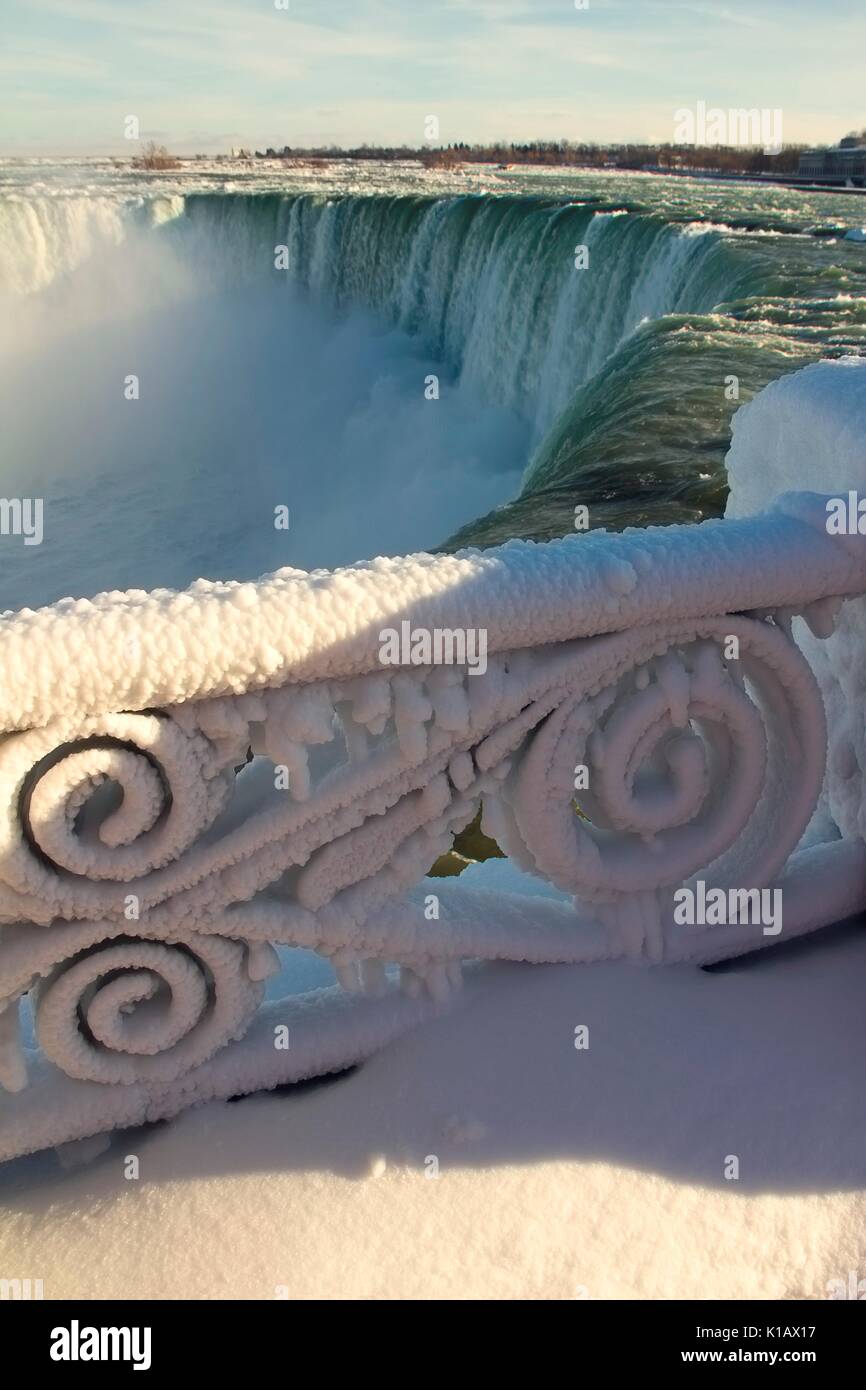 Decorative iron fence covered by thick layer of frozen mist. Niagara