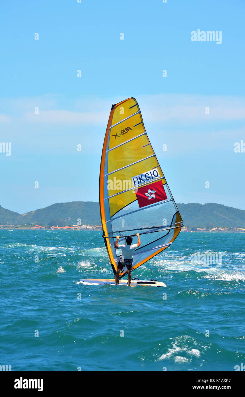 Buzios, Brasil - February 24, 2013: Windsurfing in the clear and calm waters of Buzios. Stock Photo