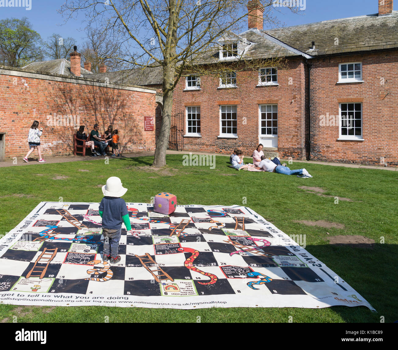 England, Nottinghamshire - Clumber Park, National Trust large estate open to public. The gatehouse, former stables. Child playing giant snakes and lad Stock Photo
