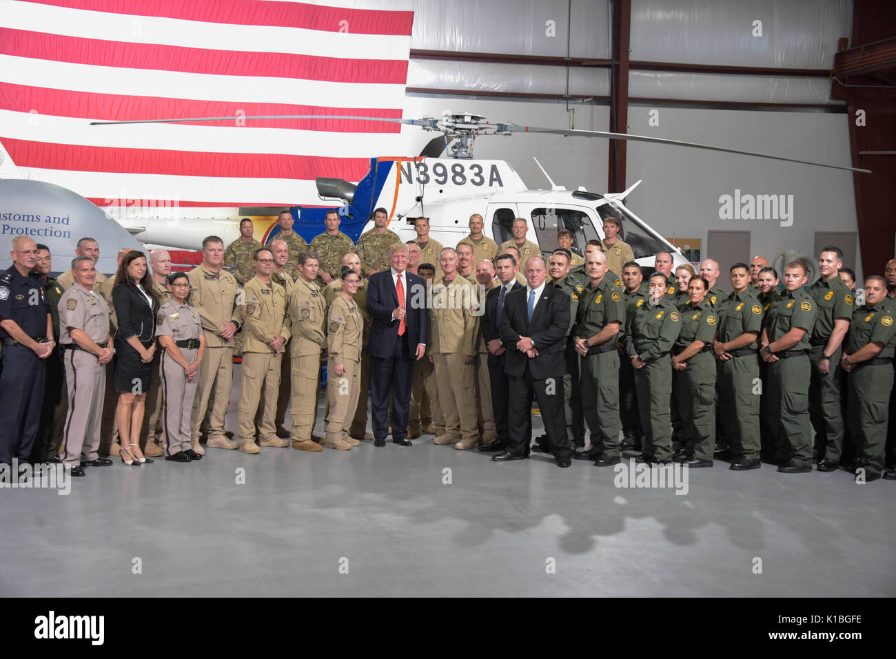 U.S. President Donald Trump poses for a group photo with U.S. Customs and Border Protection and ICE officers during a visit to the Yuma Border Patrol Station August 22, 2017 in Yuma, Arizona. Stock Photo