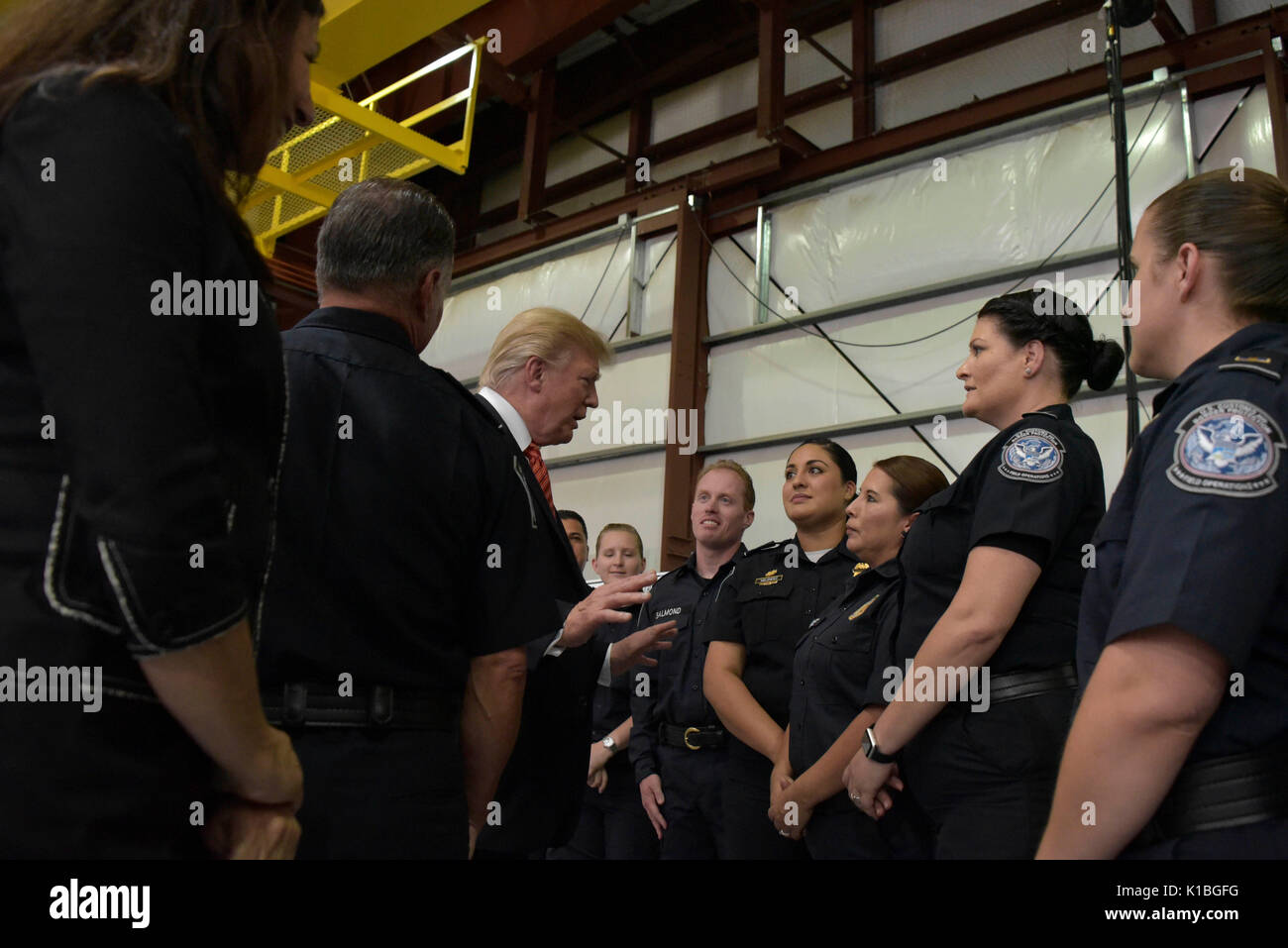 U.S. President Donald Trump speaks with U.S. Customs and Border Protection officers during a visit to the Yuma Border Patrol Station August 22, 2017 in Yuma, Arizona. Stock Photo