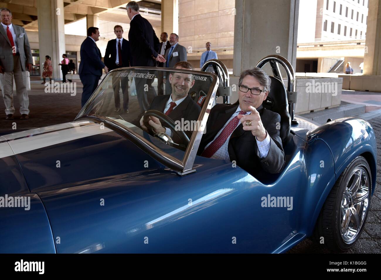 Rick Perry Printer U.S. Secretary of Energy Rick Perry, right, sits behind the wheel of a ...