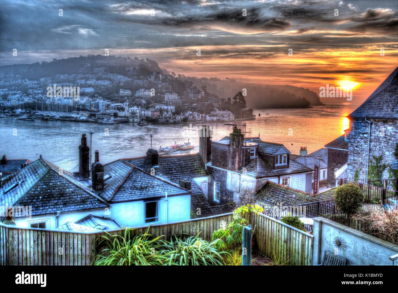 Town of Dartmouth, England. Elevated sunrise rooftop view of Dartmouth and the River Dart, with Kingswear in the background. Stock Photo