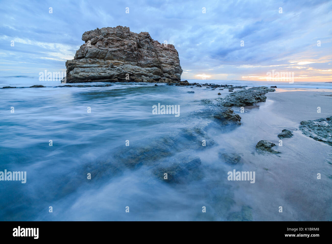 Big rock beach sunset long exposure Stock Photo - Alamy