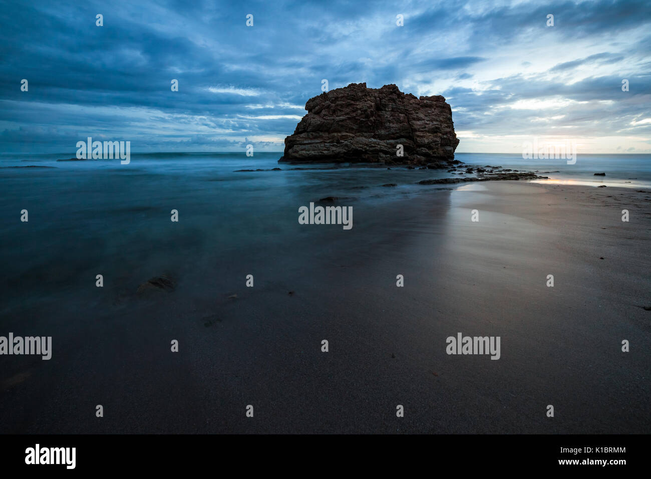 Big rock beach sunset long exposure Stock Photo - Alamy