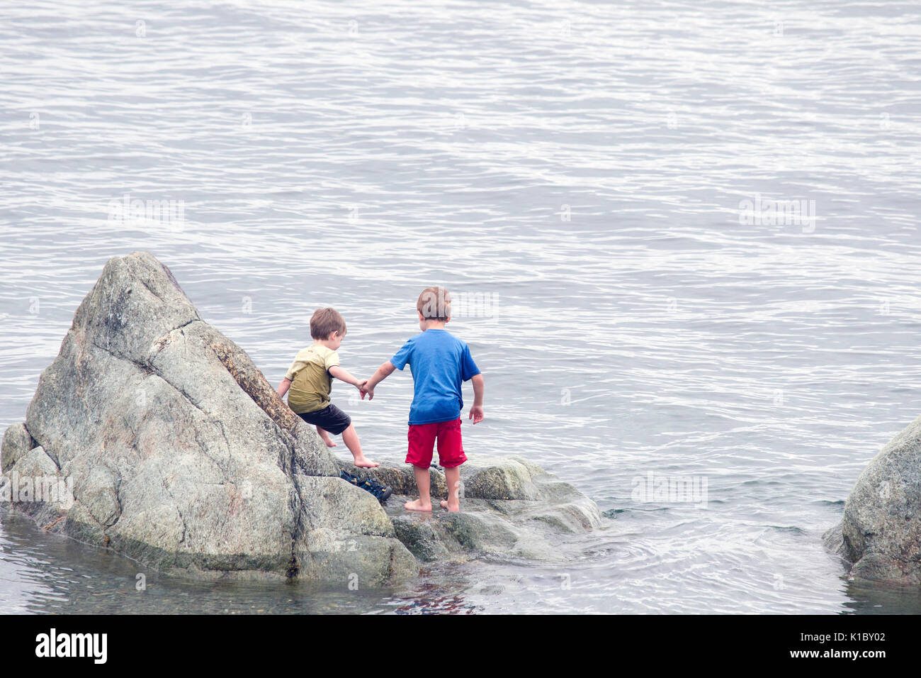 Two boys holding hands hi-res stock photography and images - Alamy